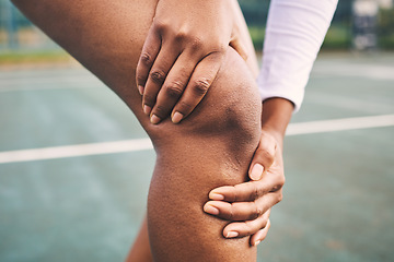 Image showing Knee injury, sport pain and netball athlete on a outdoor sports court with joint or muscle problem. Training, exercise and black woman hands holding legs with muscle and wellness issue from run