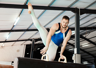 Image showing Sports, gymnastics and man training on a beam for balance, flexibility and strength in the gym. Fitness, athlete and male gymnast practicing a routine for a competition or performance in an arena.