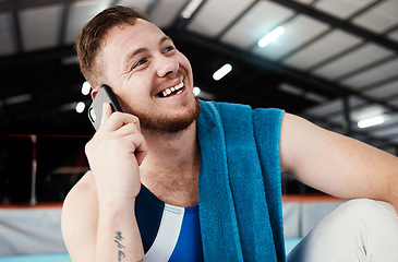 Image showing Phone call, sports and man relaxing after training, workout or competition in arena or studio. Fitness, gymnastics and happy male athlete gymnast with a smile on a mobile conversation after practice.