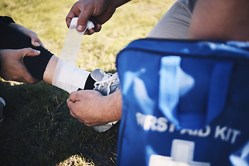 Image showing First aid, hands and man medic with ankle sports injury at field for running, training or marathon practice. Medical, closeup and emergency service for runner person with injured foot during workout