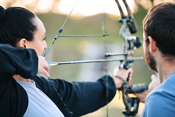 Image showing Archery, woman and target training with an instructor on a field for hobby, aim and control. Arrow, practice and archer people together outdoor for hunting, precision and weapon, shooting competition