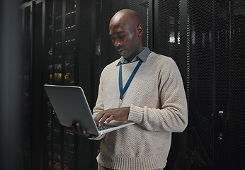 Image showing Server room, laptop and black man technician with data center management, system and cybersecurity. Focus, serious and inspection of engineering or programmer person with information technology code