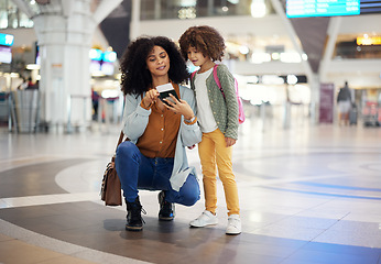 Image showing Travel, passport and mother with her child in the airport checking their boarding pass together. Trip, technology and woman browsing on a cellphone with girl kid while waiting for flight in terminal.