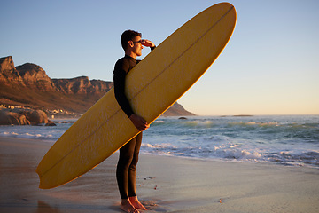 Image showing Surfer, man and beach with looking, waves and hand by eyes for safety from sun, thinking or planning morning. Ocean athlete, surfboard or water for fitness, sports and tropical adventure for exercise