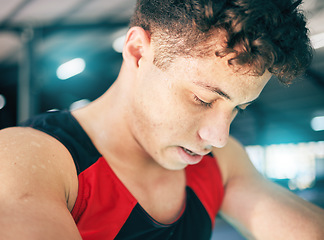 Image showing Fitness, sweat and man in gym, tired and exercise with wellness, healthy lifestyle and training. Sports break, male and athlete sweating, drops and exhausted after practice, workout and breathing