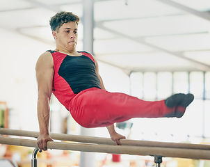 Image showing Gymnastics, man and stretching for training, routine and exercise for performance, healthy lifestyle and fitness. Gymnast, guy or male athlete in gym, practice for competition or movement for balance