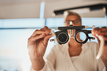 Image showing Vision, hands and test frame for optometry in hospital or clinic for ophthalmology. Doctor, healthcare and female, woman or medical optician with glasses or lens for eyes examination or eye care.