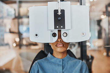 Image showing Vision, eye exam and black woman in optometry clinic for testing, eyesight and optical assessment. Healthcare, optometrist consultation and patient with medical equipment, phoropter and lens for eyes