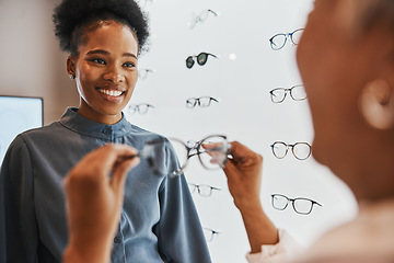 Image showing Glasses, black woman and retail customer with store worker and optician looking at lens. Eye consulting, smile and eyewear assessment in a frame shop for vision test and prescription exam for eyes
