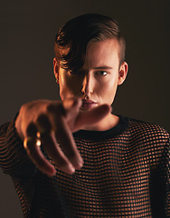 Image showing Gender neutral person, fashion and hand on dark background, trendy and edgy art. Creative, gen z and beauty, pointing and sexy with cosmetics, young and non binary with designer clothes in portrait