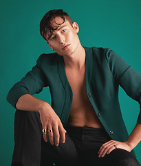 Image showing Gen z, fashion model portrait and non binary person with designer clothing with green background. Isolated, studio and modern hipster clothes of an lgbtq and serious adult with youth and cool style