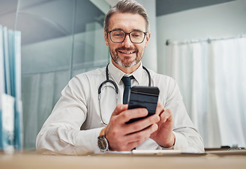 Image showing Healthcare, smile and doctor with smartphone at desk for wellness research, medical app and online consulting. Hospital, clinic and happy man with phone for internet, communication and telehealth