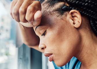 Image showing Doctor, black woman burnout and anxiety in hospital, workplace and tired in healthcare job, stress or headache. Nurse, sad and exhausted in medical clinic or depression in health hospital by window
