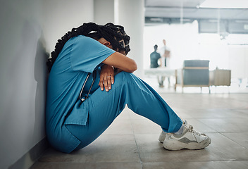 Image showing Doctor, depression and stress with black woman on floor for patient loss, surgery fail or death in hospital. Mental health, sad or anxiety for healthcare worker nurse in medical community clinic