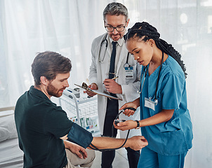 Image showing Doctor, nurse and patient with blood pressure test in hospital for heart health or wellness. Healthcare, hypertension consultation and medical physician with man for examination with sphygmomanometer