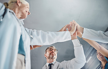 Image showing Doctor, team and high five in celebration for healthcare success, good job or winning in collaboration at clinic. Hands of medical experts in teamwork celebrating achievement, agreement or goals