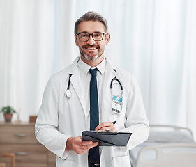 Image showing Healthcare, leadership and portrait of doctor, man in hospital for support, success and help in medical work. Health, medicine and confident mature professional with stethoscope, smile and clipboard.