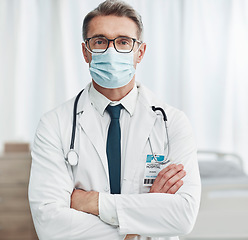 Image showing Covid, leadership and portrait of mature doctor, man in hospital for support, success and help in medical work. Health, wellness and medicine, confident professional in stethoscope, glasses and mask.