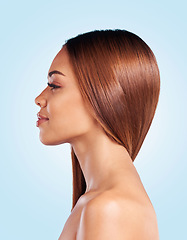 Image showing Face, hair care and skincare of woman in studio isolated on a blue background. Hairstyle cosmetics, thinking and profile of young female model with salon treatment for growth, texture and balayage.