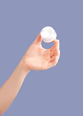 Image showing Skincare, hands and cream container in studio isolated on a purple background for hydration. Cosmetics, dermatology and woman or female model with lotion, creme or moisturizer for beauty aesthetics.