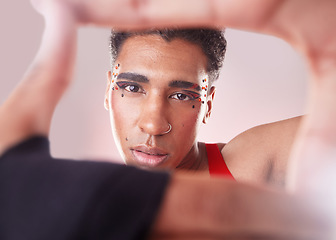 Image showing Portrait, hands and frame with black man, aesthetic and confident guy against studio background. Face, queer person and male with framing for perspective, fashion or creative with makeup or cosmetics