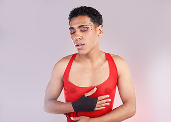 Image showing Punk, fashion and makeup man isolated on studio background for creative, art and gen z cosmetics. Gay, lgbtq and queer model or black person with danger, red and fight for love and beauty aesthetic