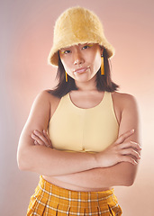 Image showing Asian woman, fashion and confident, gen z and portrait, yellow aesthetic and edgy on studio background. Streetwear style, beauty and cosmetics, female and empowerment, attitude with arms crossed