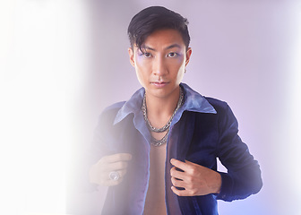 Image showing Makeup, light and portrait of gay man from Indonesia with confidence isolated on purple background. Style, aesthetic and lgbt fashion model with beauty in studio, non binary and gender neutral design