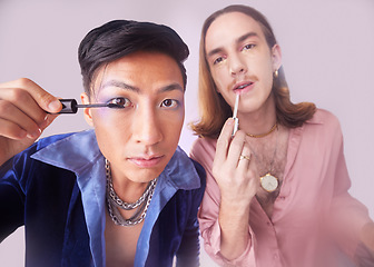 Image showing Man, gay and mascara makeup in studio with gen z friends, beauty and cosmetics for fashion by background. Lgbtq couple, cosmetic or portrait for vintage 80s aesthetic with support, solidarity or eyes