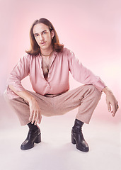 Image showing Fashion, style and lgbt, portrait of man with pride, confidence and pose isolated on pink background. Makeup, aesthetic and model with beauty in studio, creative non binary and gender neutral design.