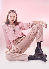 Image showing Fashion, pose and portrait of lgbt man with pride and confidence isolated on pink background. Style, creative retro aesthetic and gay model, beauty and non binary or gender neutral design in studio.