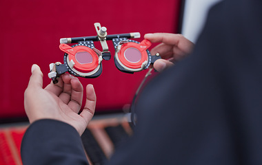 Image showing Glasses, lens and trial frame, hands with ophthalmologist tools, vision test with woman, healthcare for eyes and prescription. Optometry, eye care and optometrist, medicine and measurement