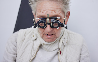 Image showing Eye exam, trial frame and senior woman in optometry clinic for vision test, eyesight and optical assessment. Ophthalmology, health and face of elderly patient with optician, optometrist and glasses
