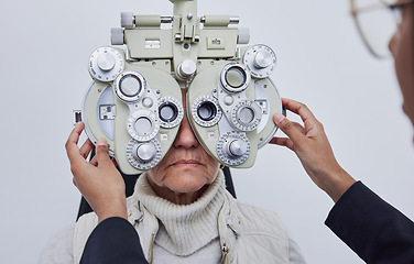 Image showing Eyes, vision exam and senior woman with optometrist in clinic for test, eyesight and optical assessment. Optometry, healthcare and optician with elderly patient, phoropter lens and medical machine