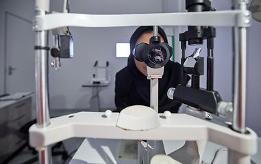 Image showing Optometry, healthcare and optometrist doing eye test in the clinic for eyecare and vision wellness. Medical, ophthalmology and muslim female optician doing optical exam with equipment at optic store.