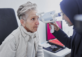 Image showing Eye exam, vision and senior woman with optometrist in clinic for eyes test, eyesight and optical assessment. Optometry, healthcare and Muslim optician and patient for glasses, lens and retinal camera