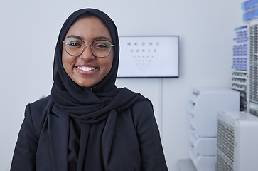 Image showing Hijab, happy muslim woman and optometrist portrait in a doctor office ready for eye test with chart. Healthcare, eyes wellness and proud clinic worker with a smile with company vision and success