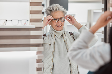 Image showing Senior woman, glasses and eye care at mirror with patient shopping for vision lens or frame in optics shop. Happy customer person smile for decision on optometry product choice for eyes and wellness