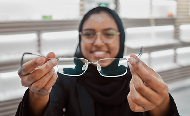 Image showing Decision, portrait and Muslim woman with glasses for vision, help and shopping at a store. Optometry, retail and Islamic optician helping with eyewear fitting, consultation and eye care frame