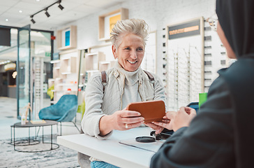 Image showing Eye care, senior woman and glasses for patient shopping for vision lens or frame at optics store. Happy customer person talking to service consultant for decision on optometry case choice for eyes