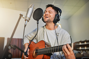 Image showing Guitar, microphone and singing in studio for album recording, theatre label or radio musician industry. Man, singer and guitarist headphones for instrument production, theater sound or karaoke media