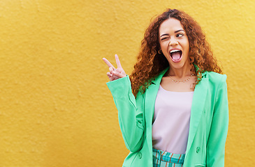 Image showing Woman, peace and wink on yellow background, color backdrop and mockup space. Happy female, v sign and hands of cool model for victory, winking and fun mood with happiness, mock up and gen z fashion