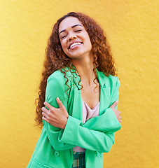 Image showing Black woman, fashion and self love on yellow wall background for motivation, beauty and style. Gen z Colombia person with curly hair outdoor for freedom, hug and positive mindset for trend