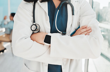 Image showing Doctor, hands and arms crossed with stethoscope for healthcare cardiology or life insurance at hospital. Closeup hand of confident medical expert, professional or specialist standing ready at clinic