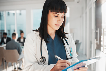 Image showing Doctor, woman and writing on checklist in hospital for research or wellness report. Healthcare clinic, planning and female medical professional with clipboard to write notes for health information.