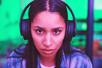 Image showing Headphones, portrait or gaming woman in neon home with focus, strategy or serious face expression for esports. Zoom, player or video gamer in night house with cyberpunk music or challenge mindset