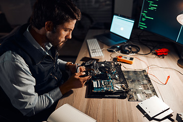 Image showing Night, technician and working on motherboard repair overtime and manufacturing an electronic device in a workshop or shop. Person, man and guy fixing hardware of a computer for technology in a lab