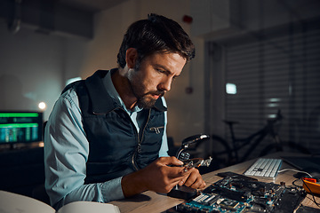 Image showing Man, circuit and it repair workshop in night for maintenance, computer tech or industry with focus. Technician, motherboard and information technology in dark with electronics, engineering and tools