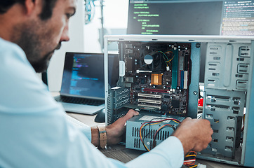 Image showing It technician, engineer and computer hardware with a man working to fix or maintenance technology. Hands of expert IT person in office data center for system repair, engineering or motherboard update