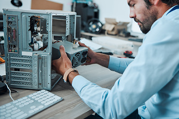 Image showing Engineering, technician and man fixing the hardware of a computer in workshop or office. IT, technology and male professional doing maintenance or repairs on microcircuit or motherboard in workplace.